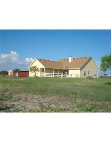 a view of an house with backyard space and porch