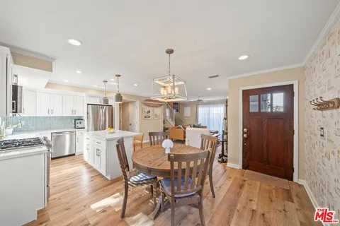 a view of a dining room with furniture window and wooden floor