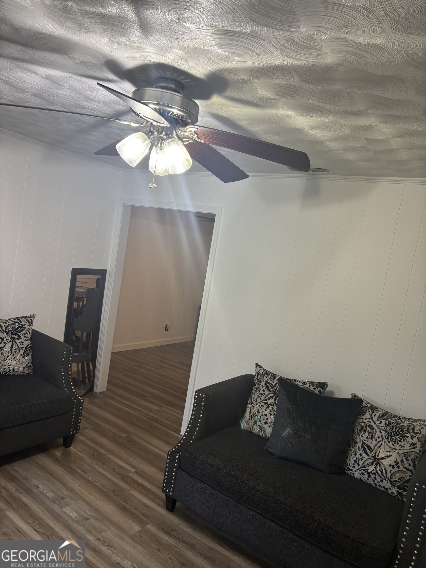 614 Alfred C Carson Street Sandersville, GA 31082 - Photo 11 of 22 a living room with furniture and a chandelier