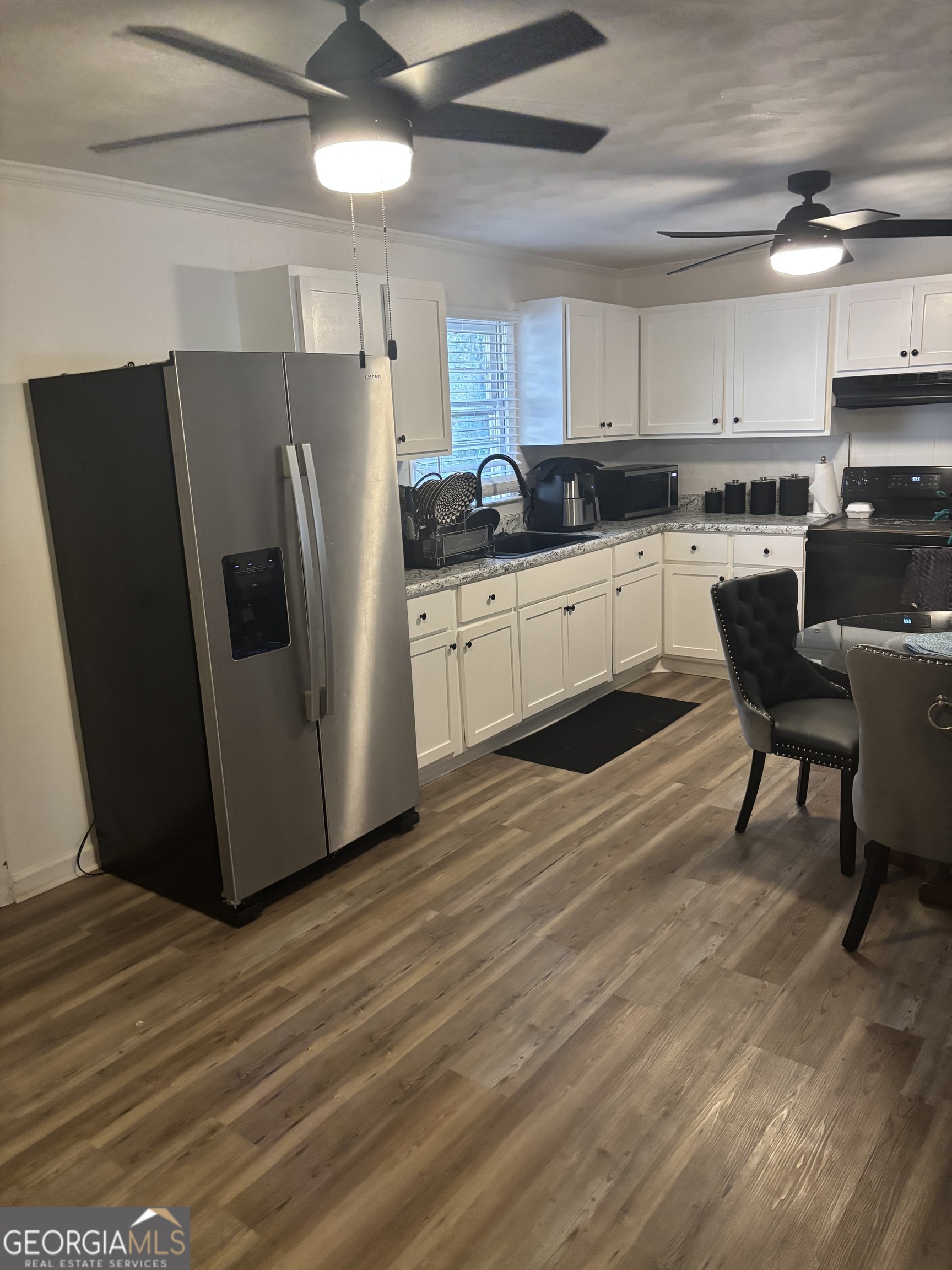 614 Alfred C Carson Street Sandersville, GA 31082 - Photo 17 of 22 a kitchen with stainless steel appliances a refrigerator sink and white cabinets