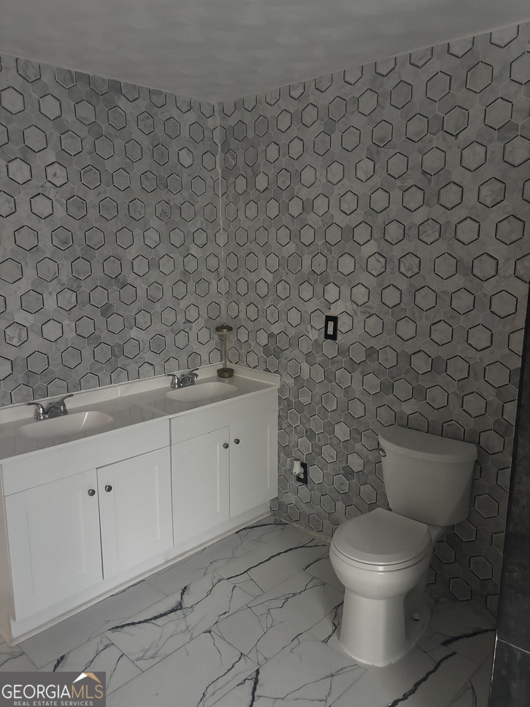 614 Alfred C Carson Street Sandersville, GA 31082 - Photo 20 of 22 a bathroom with a toilet and a sink