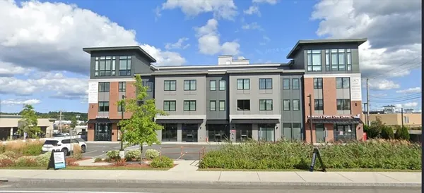 a front view of a building with a garden