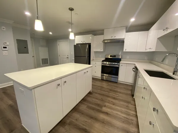 a kitchen with a sink a stove a refrigerator and a oven