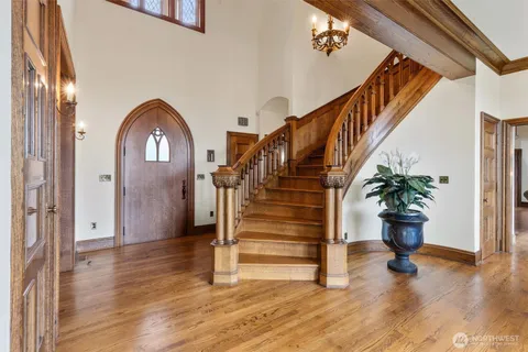 a view of entryway and hall with wooden floor