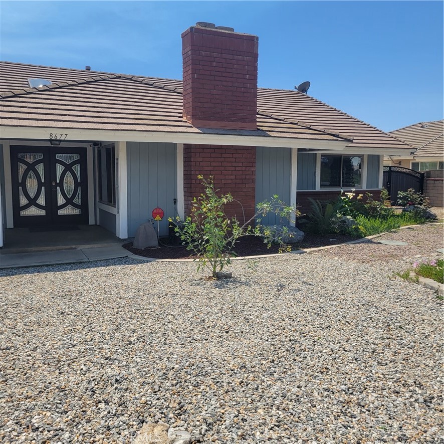 8677 Hillside Road Rancho Cucamonga, CA 91701 - Photo 1 of 1 front view of a house with a yard