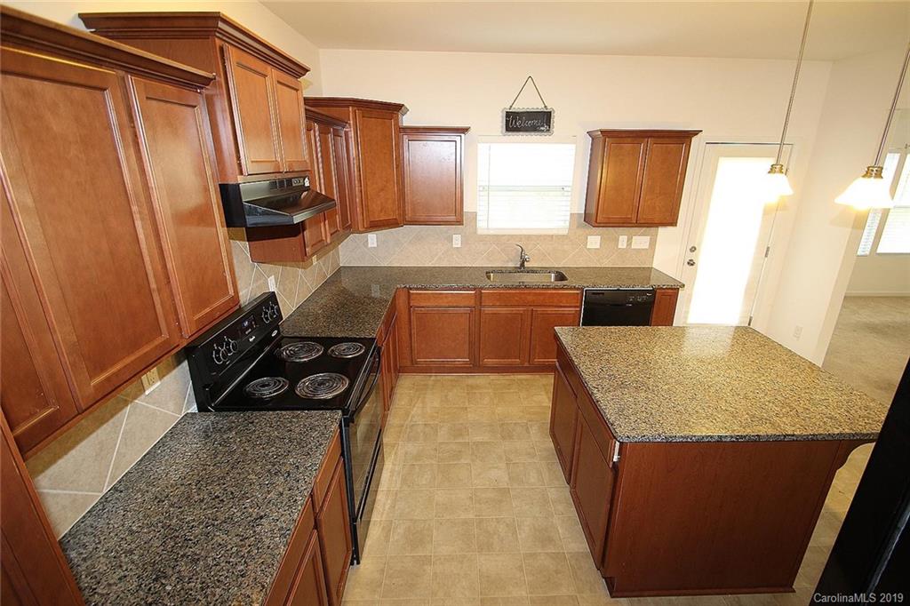 10603 Pointer Ridge Drive Charlotte, NC 28214 - Photo 11 of 37 a kitchen with sink refrigerator and stove