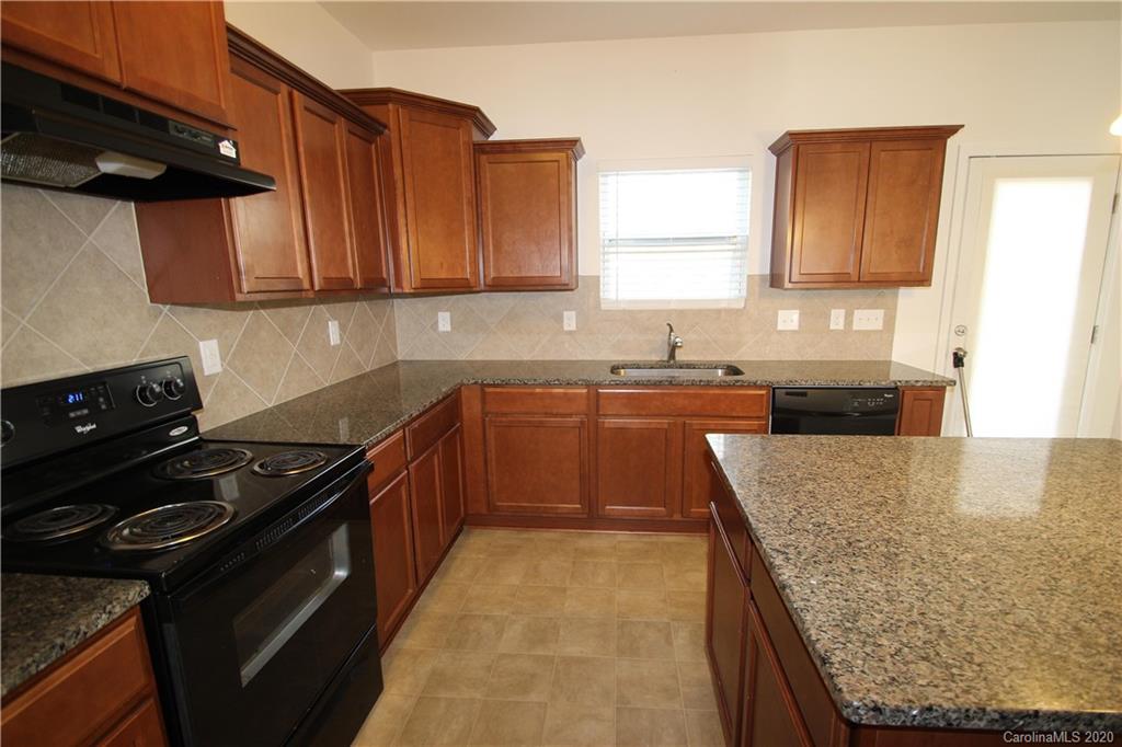 10603 Pointer Ridge Drive Charlotte, NC 28214 - Photo 13 of 37 a kitchen with stainless steel appliances granite countertop a stove a sink and a microwave