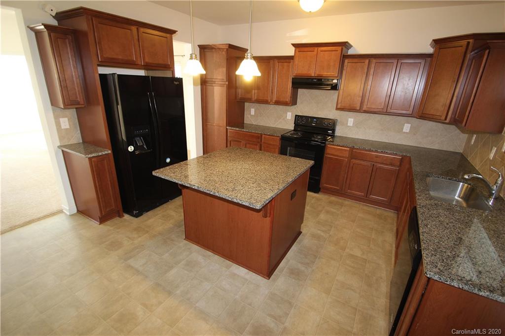 10603 Pointer Ridge Drive Charlotte, NC 28214 - Photo 14 of 37 a kitchen with stainless steel appliances granite countertop wooden cabinets a refrigerator and a sink