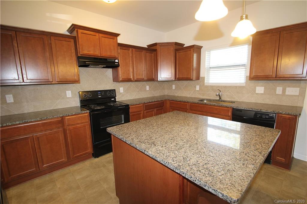 10603 Pointer Ridge Drive Charlotte, NC 28214 - Photo 15 of 37 a kitchen with stainless steel appliances granite countertop a sink stove and refrigerator