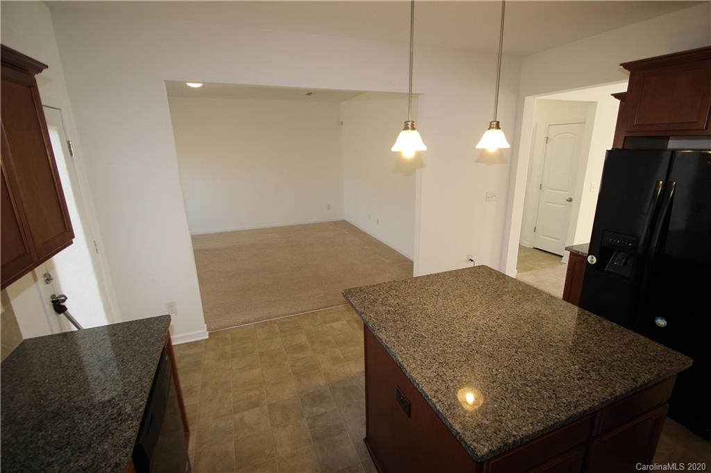 10603 Pointer Ridge Drive Charlotte, NC 28214 - Photo 16 of 37 a kitchen with a sink a counter top space and a refrigerator