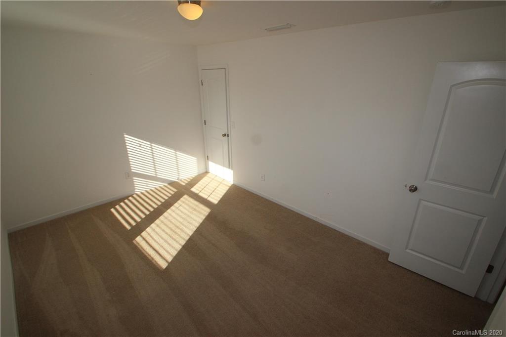 10603 Pointer Ridge Drive Charlotte, NC 28214 - Photo 27 of 37 a view of an empty room and wooden floor