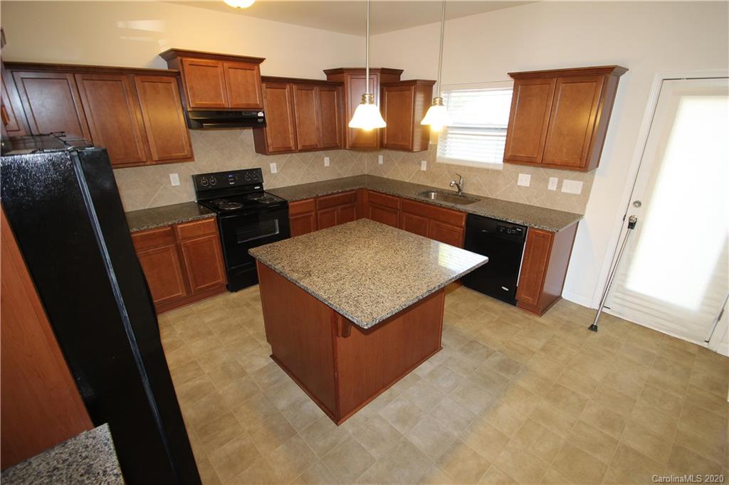 10603 Pointer Ridge Drive Charlotte, NC 28214 - Photo 10 of 37 a kitchen with stainless steel appliances granite countertop a refrigerator a stove and a sink