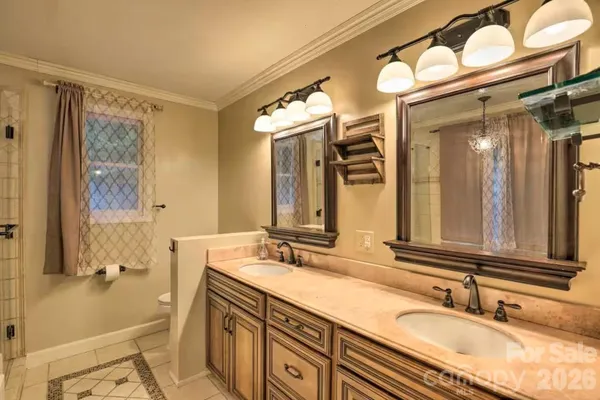 a bathroom with a granite countertop bathtub shower and a sink