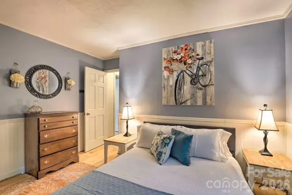 a bedroom with furniture and a large window