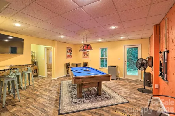 a room with pool table and window