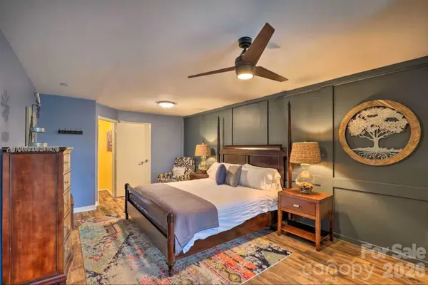 a bedroom with a bed and a lamp