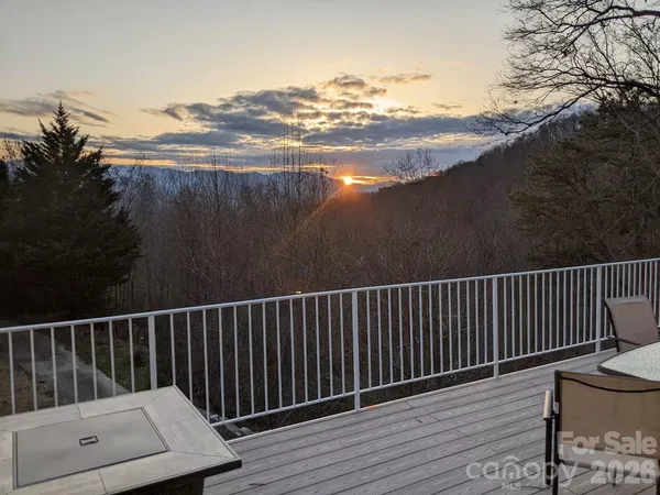 a view of balcony with wooden floor and fence