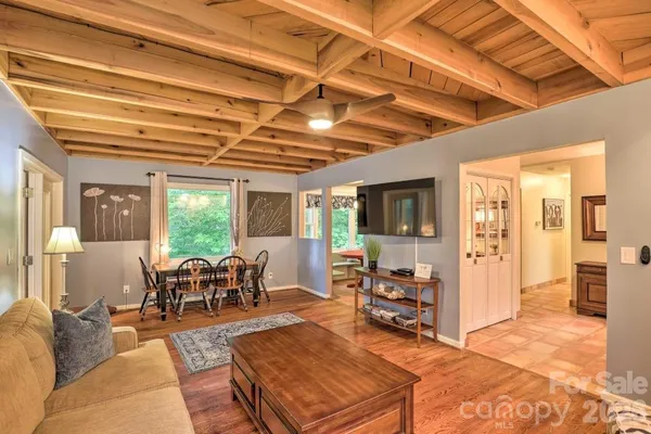 a living room with furniture and wooden floor