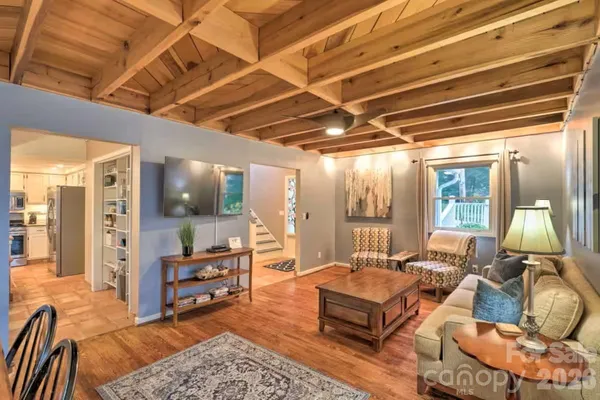 a living room with furniture a table and chairs