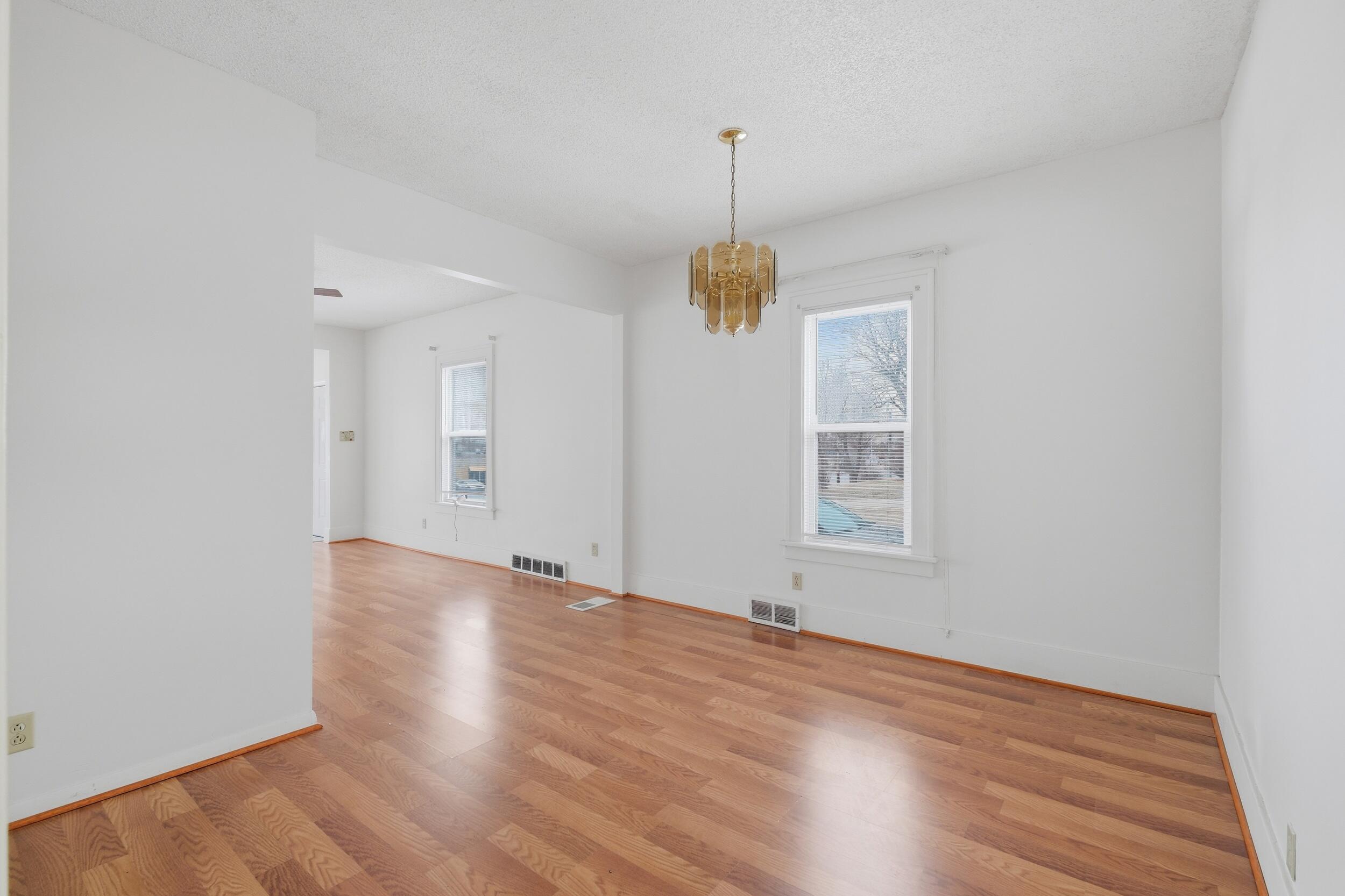 2418 Ridge Road Highland, IN 46322 - Photo 12 of 44 a view of an empty room with a window and wooden floor