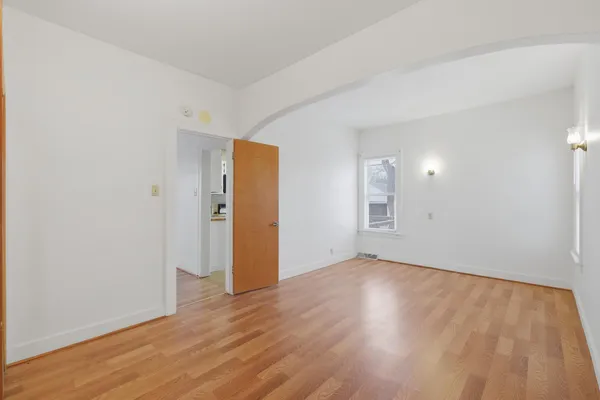 a view of an empty room with wooden floor