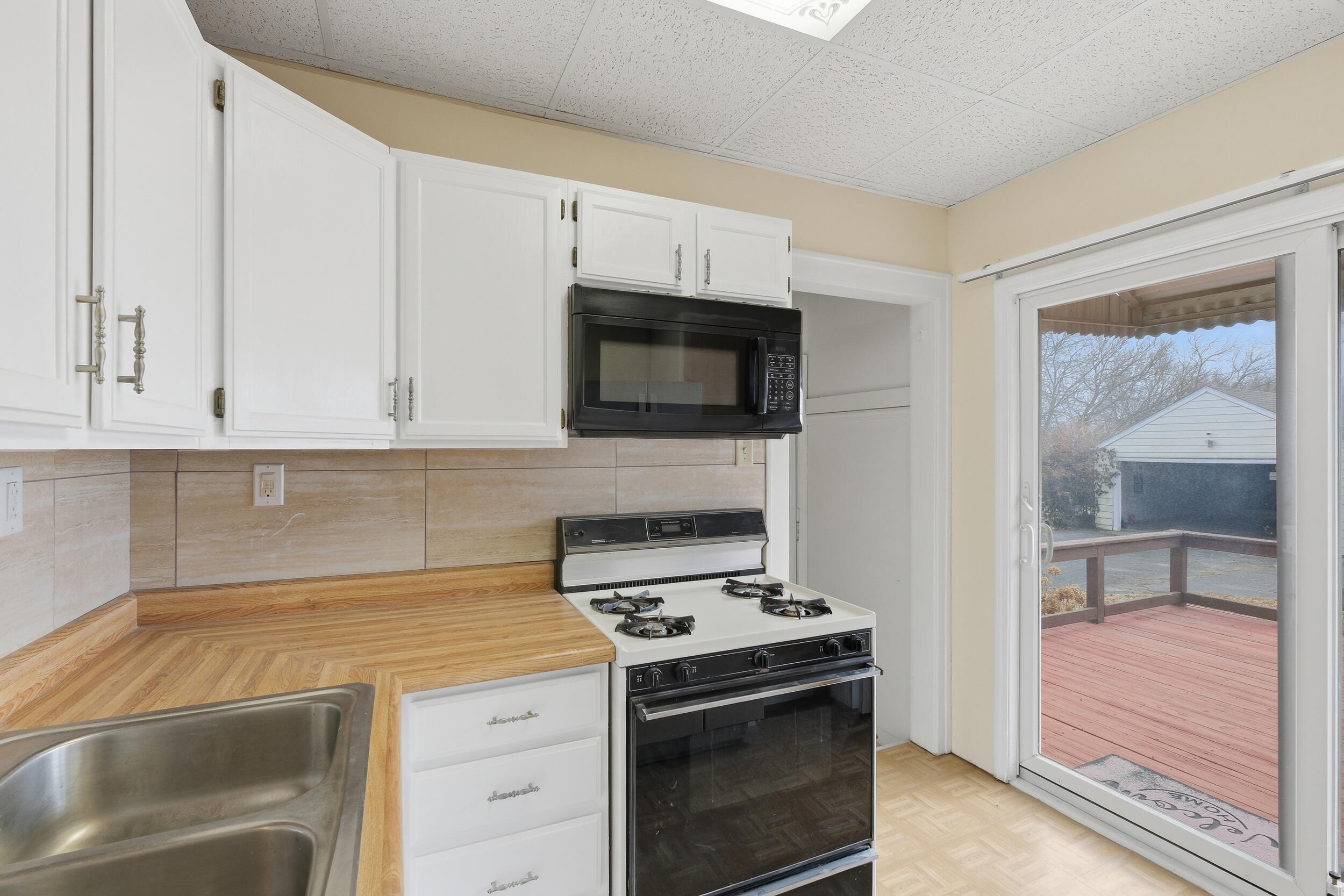 2418 Ridge Road Highland, IN 46322 - Photo 19 of 44 a kitchen with granite countertop a stove and a microwave