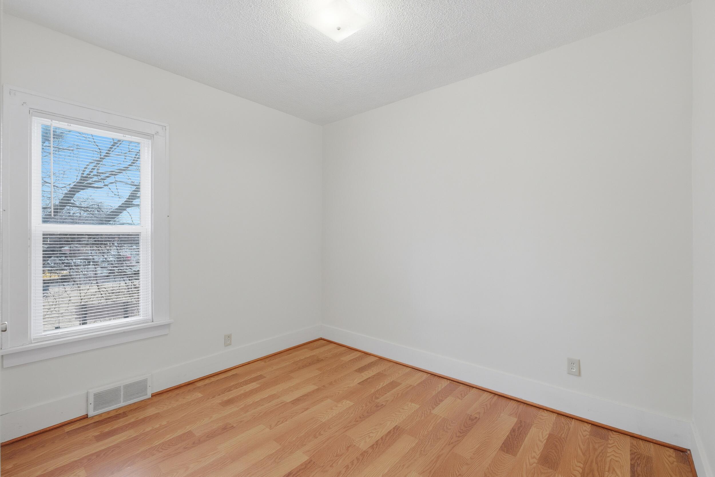 2418 Ridge Road Highland, IN 46322 - Photo 22 of 44 a view of an empty room with wooden floor and a window