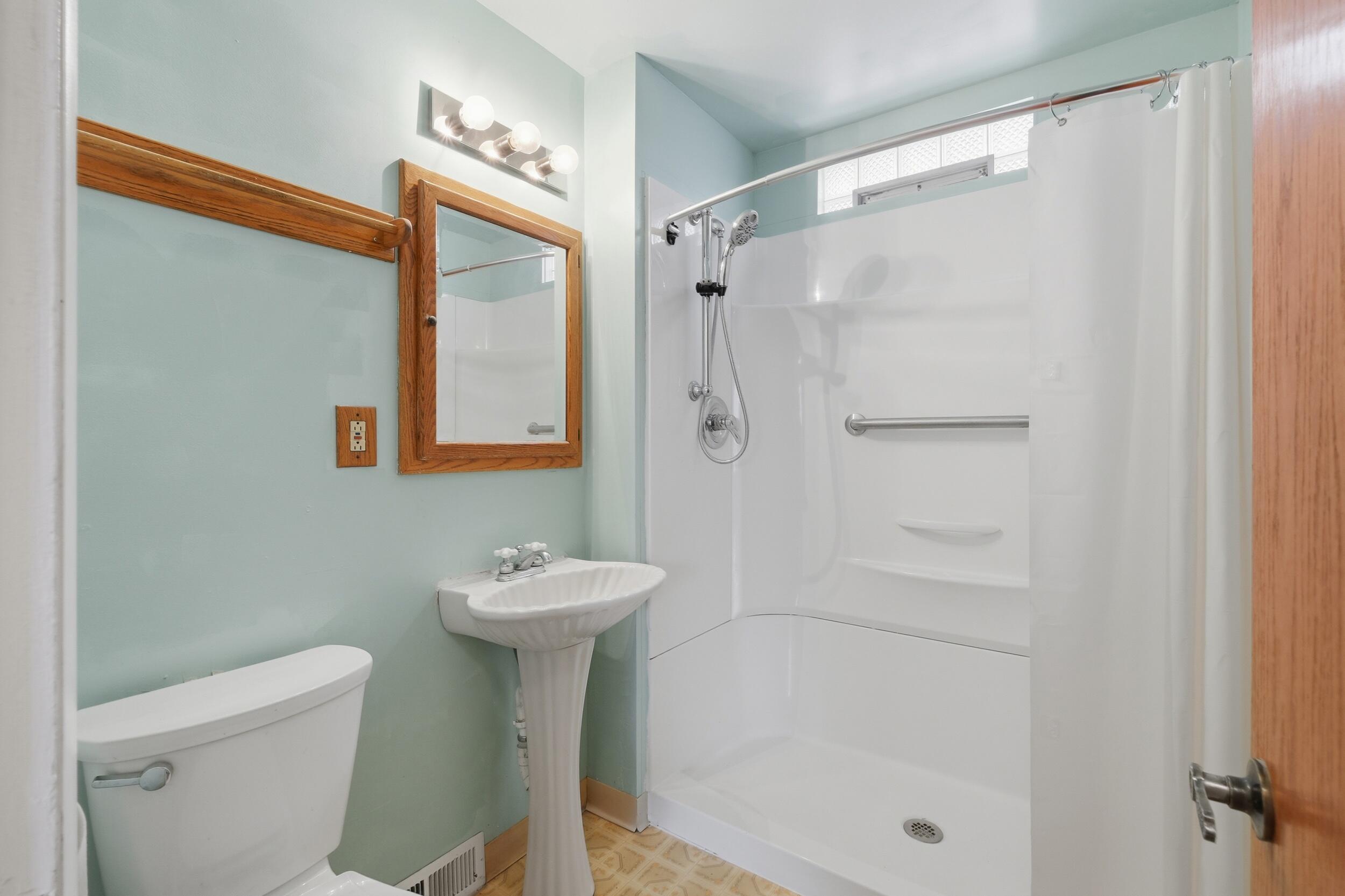 2418 Ridge Road Highland, IN 46322 - Photo 26 of 44 a bathroom with a shower a toilet and sink