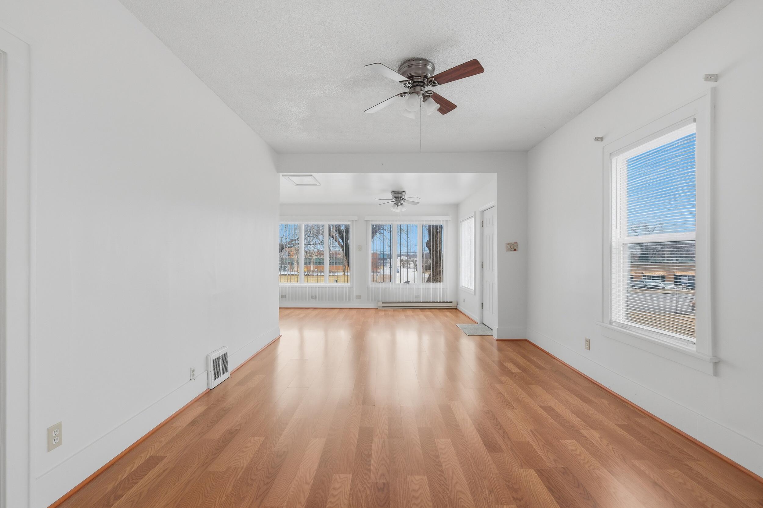 2418 Ridge Road Highland, IN 46322 - Photo 3 of 44 a view of an empty room with a window and wooden floor