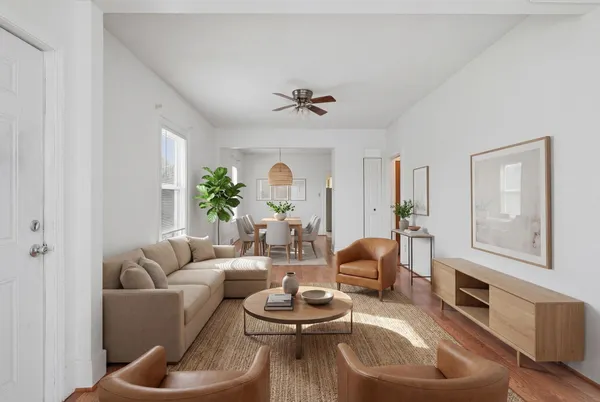 a living room with furniture and a chandelier