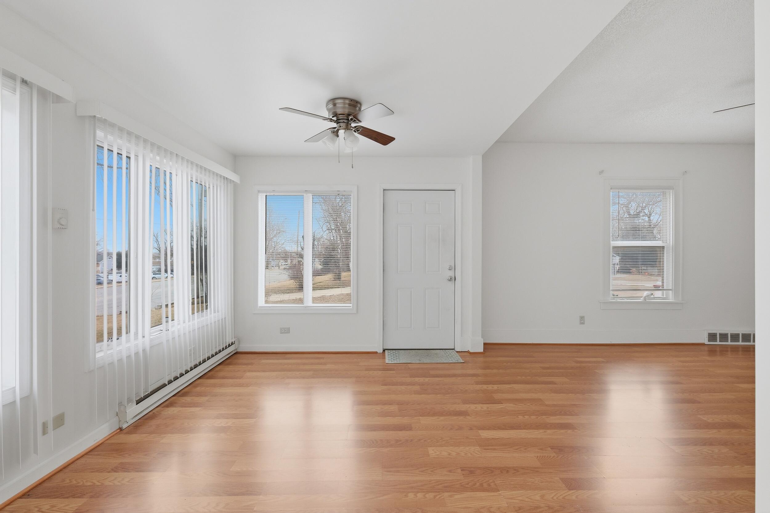 2418 Ridge Road Highland, IN 46322 - Photo 7 of 44 a view of an empty room with wooden floor and a window