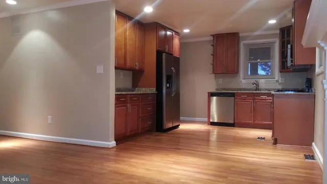 a kitchen with stainless steel appliances granite countertop a refrigerator and a sink
