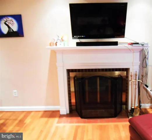 a living room with a fireplace and a flat screen tv