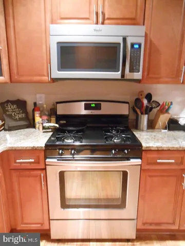 a stove top oven sitting inside of a kitchen