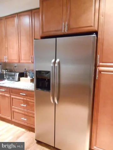 a kitchen with a refrigerator and cabinets