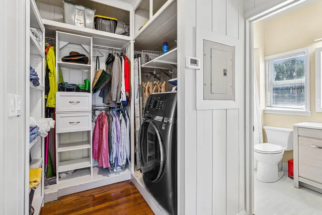 a view of walk in closet with clothes and shoes