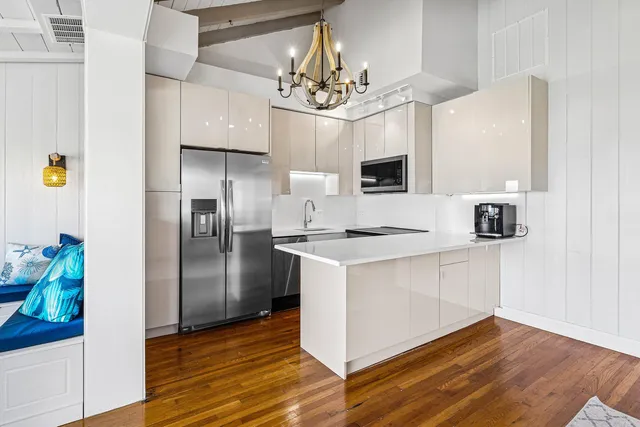 a kitchen with kitchen island granite countertop stainless steel appliances a sink and a refrigerator