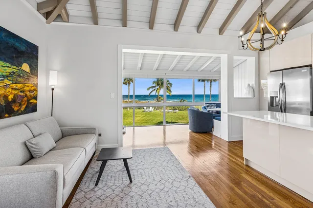 a living room with stainless steel appliances kitchen island granite countertop furniture and a kitchen view