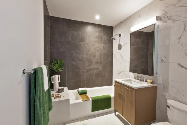 a bathroom with a bathtub a sink and a mirror