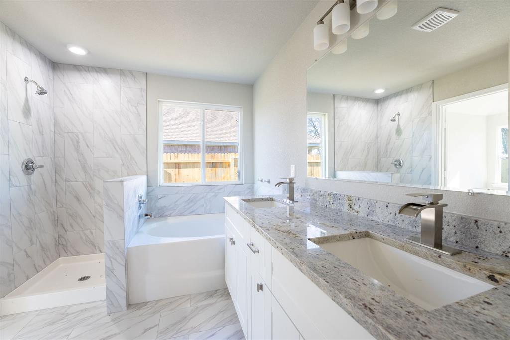 1032 Springview Lane Mabank, TX 75147 - Photo 6 of 15 Full bathroom featuring a marble finish shower, double vanity, a bath, and healthy amount of natural light