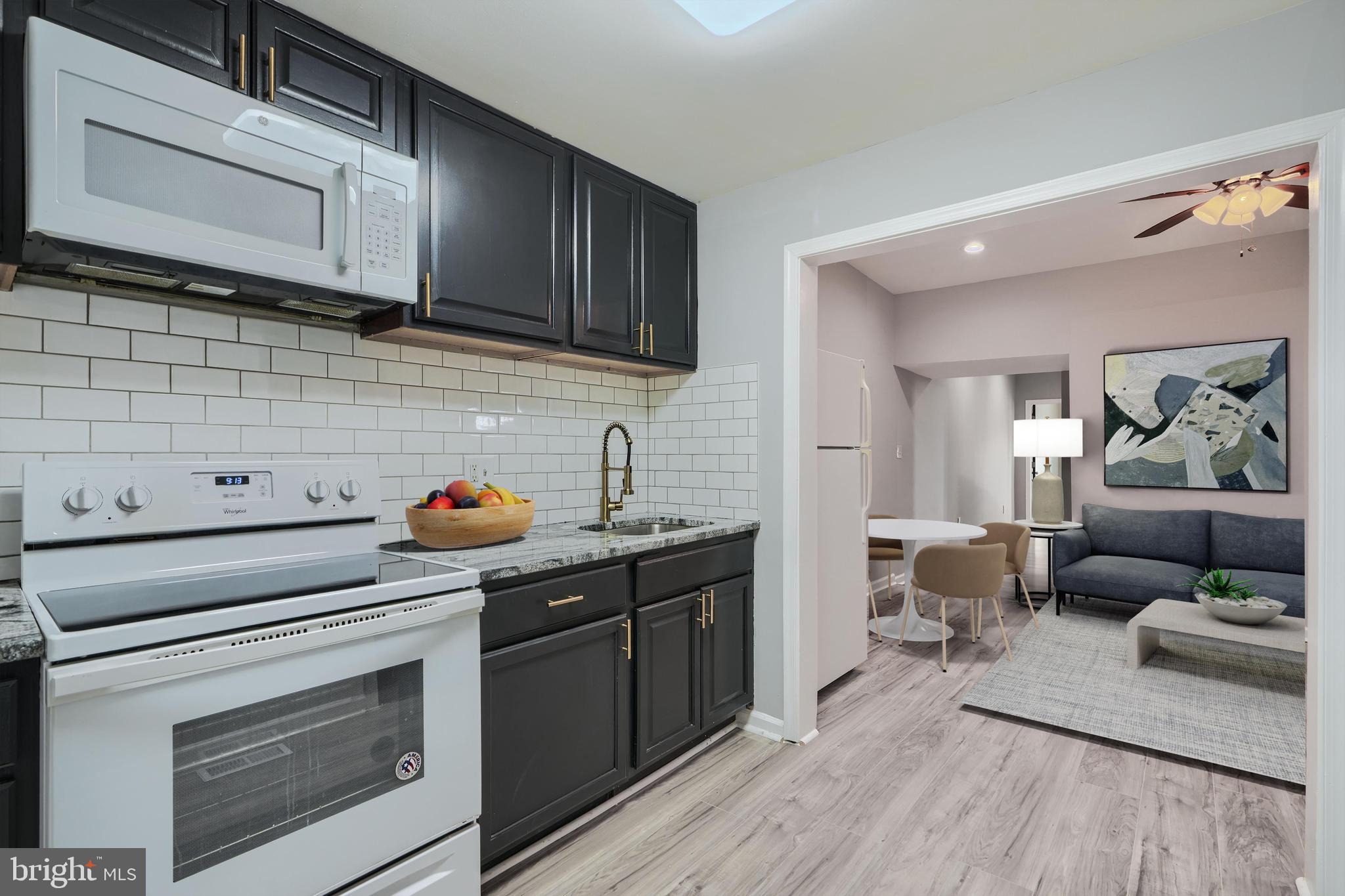 3014 Hamilton Avenue, Unit 1 Baltimore, MD 21214 - Photo 14 of 36 a kitchen with stainless steel appliances a stove microwave and cabinets
