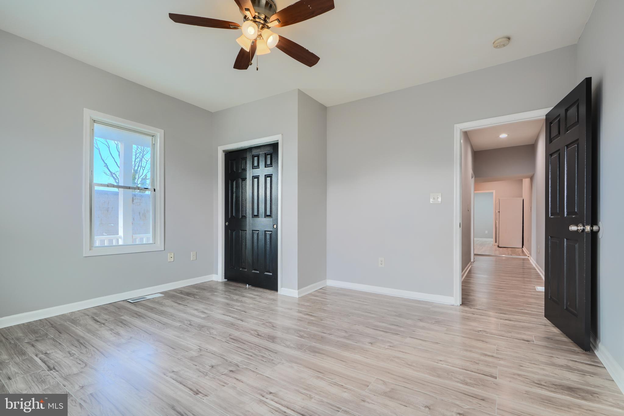 3014 Hamilton Avenue, Unit 1 Baltimore, MD 21214 - Photo 21 of 36 a view of an empty room with wooden floor and a window