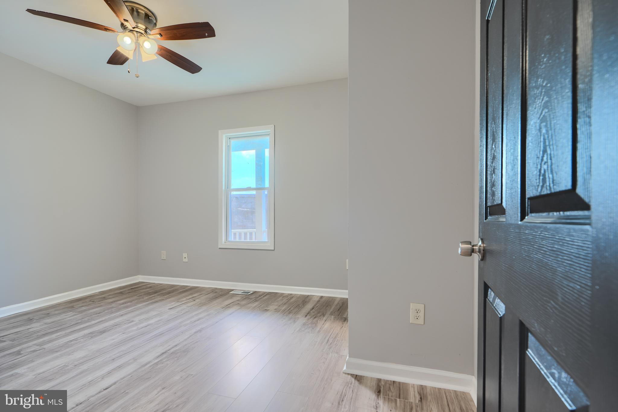 3014 Hamilton Avenue, Unit 1 Baltimore, MD 21214 - Photo 23 of 36 a view of room with hardwood floor and ceiling fan