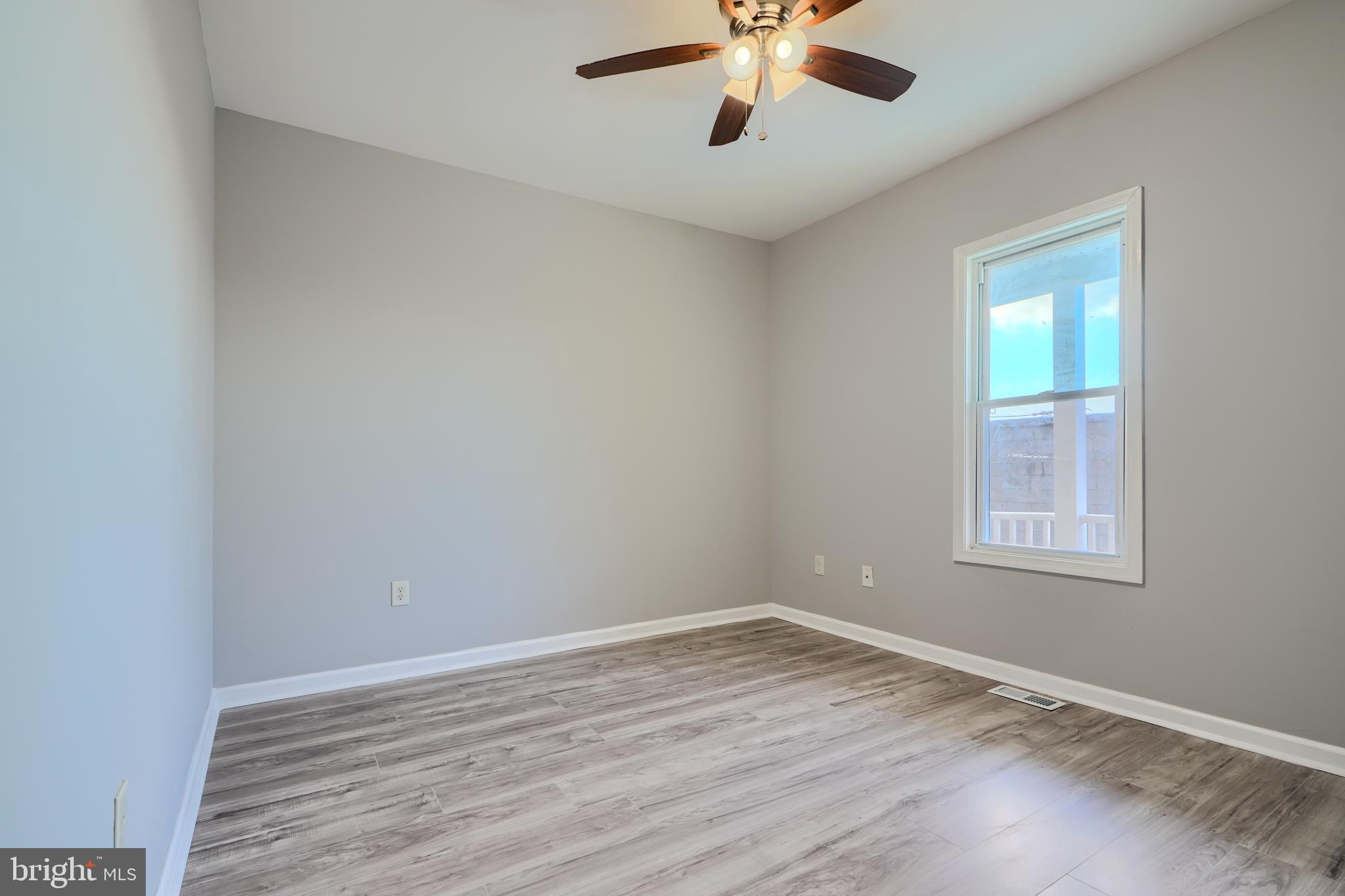 3014 Hamilton Avenue, Unit 1 Baltimore, MD 21214 - Photo 25 of 36 wooden floor in an empty room with a window