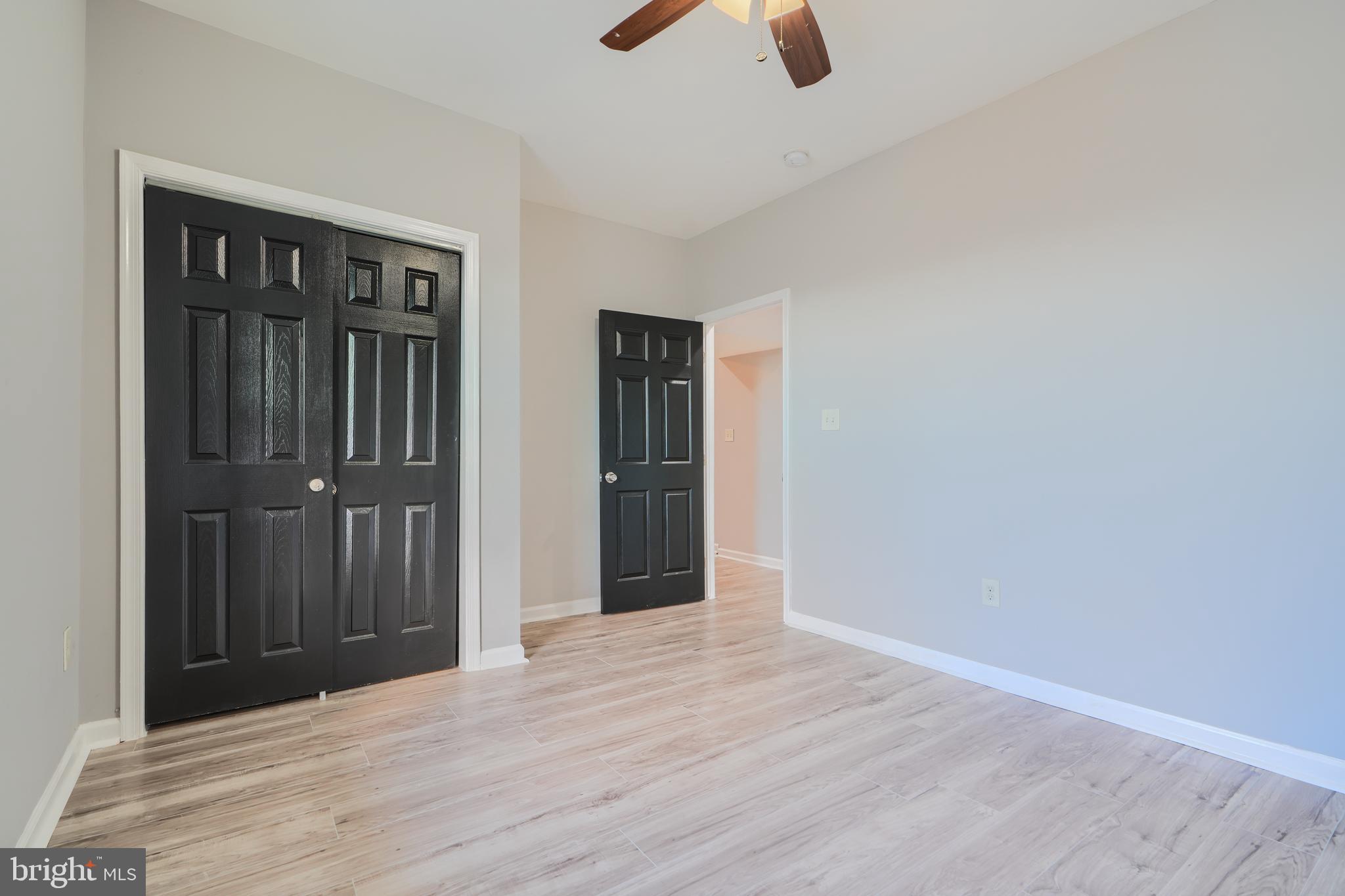 3014 Hamilton Avenue, Unit 1 Baltimore, MD 21214 - Photo 26 of 36 an empty room with ceiling fan and window
