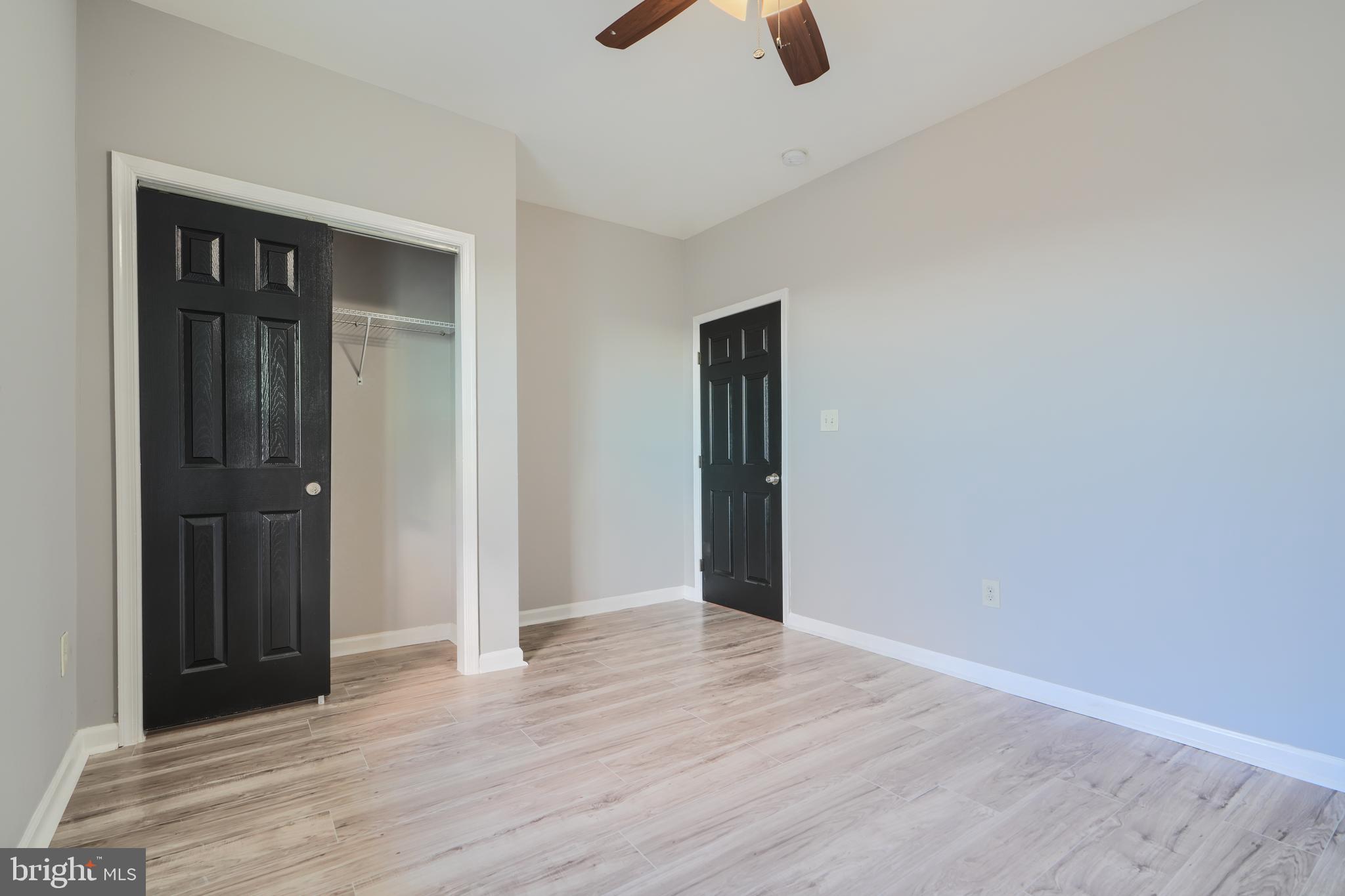 3014 Hamilton Avenue, Unit 1 Baltimore, MD 21214 - Photo 27 of 36 wooden floor ceiling fan and window in a room