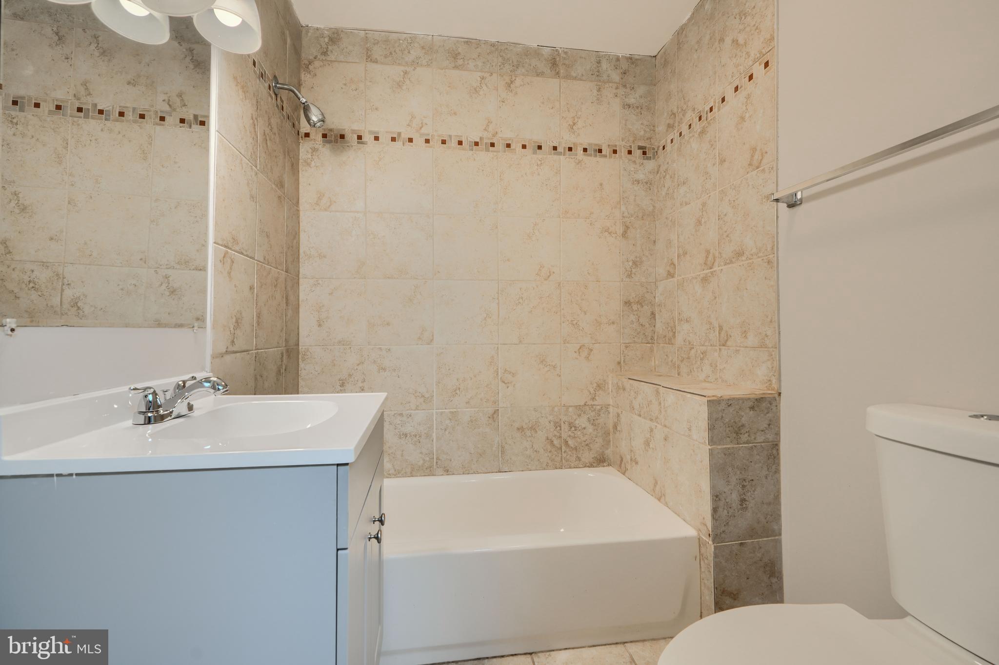 3014 Hamilton Avenue, Unit 1 Baltimore, MD 21214 - Photo 28 of 36 a bathroom with a sink a toilet and shower