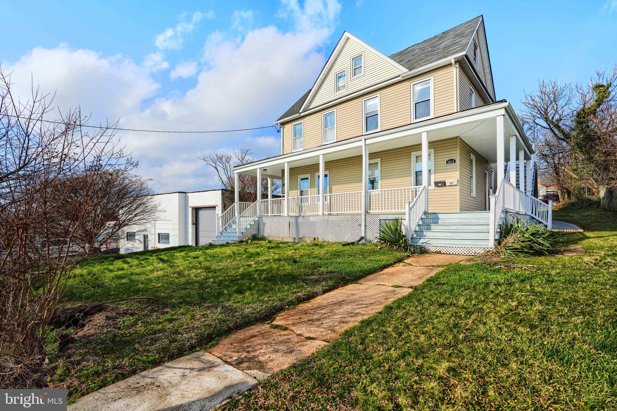 3014 Hamilton Avenue, Unit 1 Baltimore, MD 21214 - Photo 3 of 36 a front view of a house with a yard