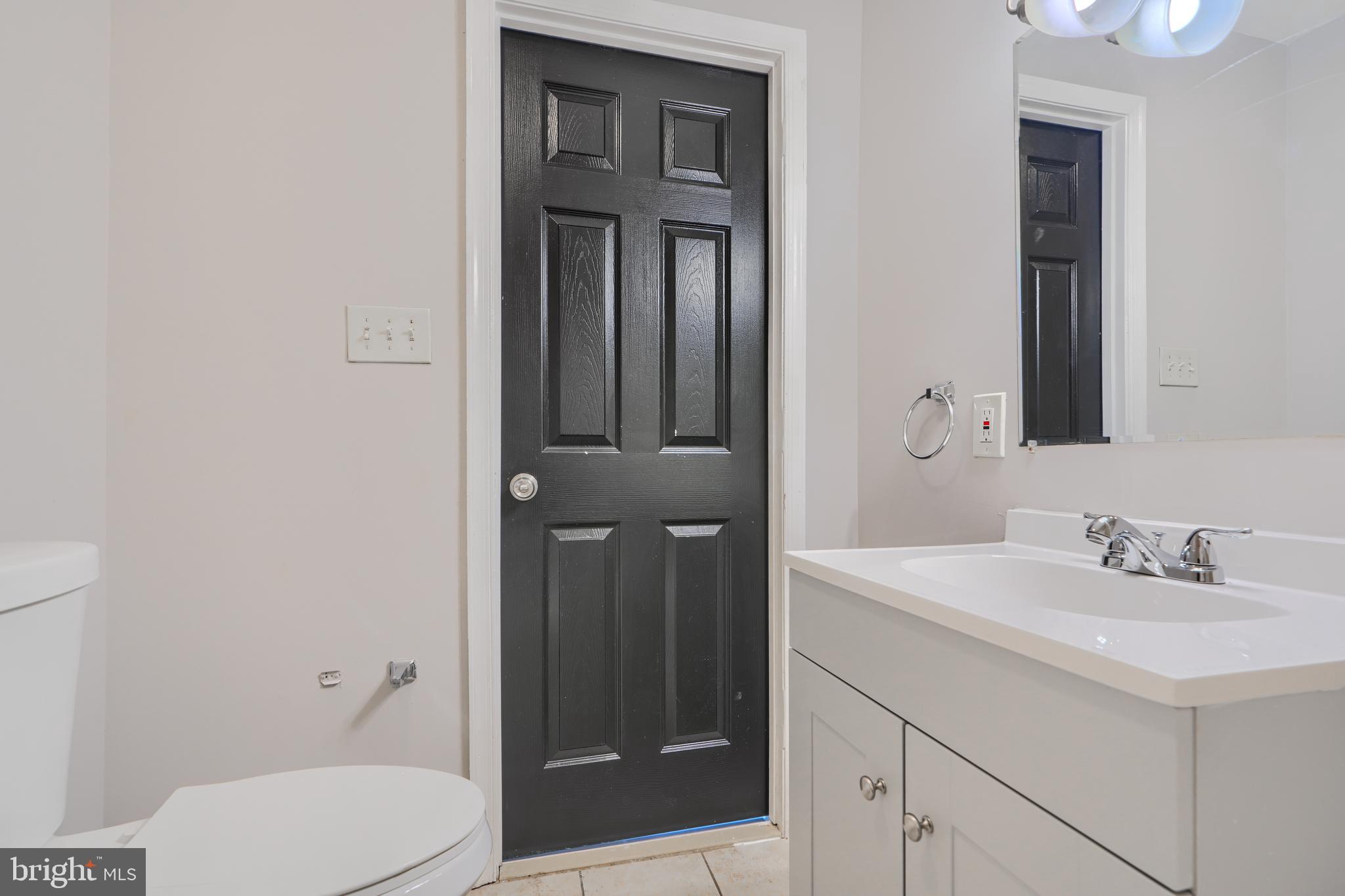 3014 Hamilton Avenue, Unit 1 Baltimore, MD 21214 - Photo 31 of 36 a bathroom with a sink a toilet and shower
