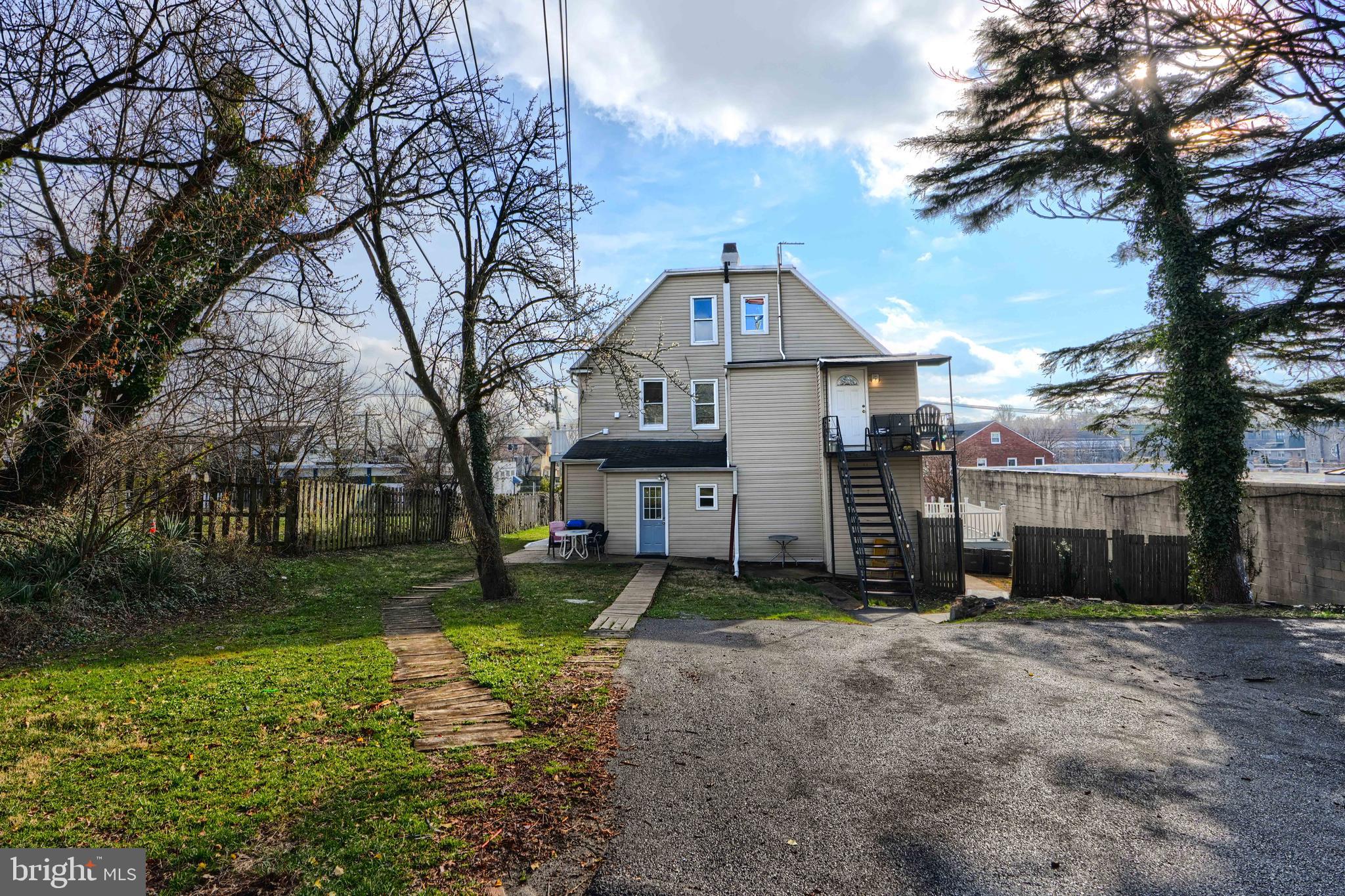 3014 Hamilton Avenue, Unit 1 Baltimore, MD 21214 - Photo 35 of 36 a front view of a house with a yard and trees